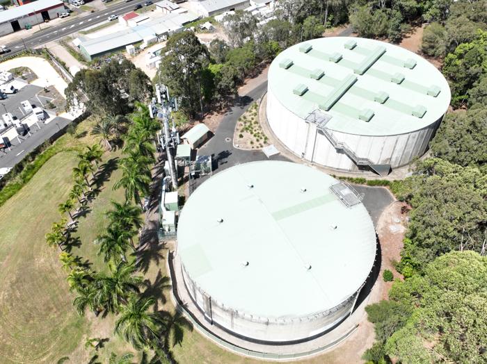 Aerial view of two water reservoirs and a communications tower